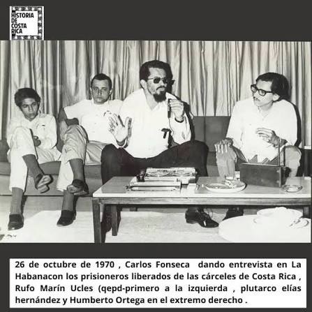 Cuatro hombres sentados en un sofá conversan frente a una grabadora; el pie de foto fecha la entrevista el 26 de octubre de 1970 en La Habana
